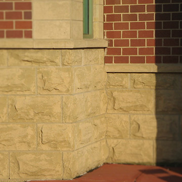 Masonry Exterior of building wall with masonry base and window treatment